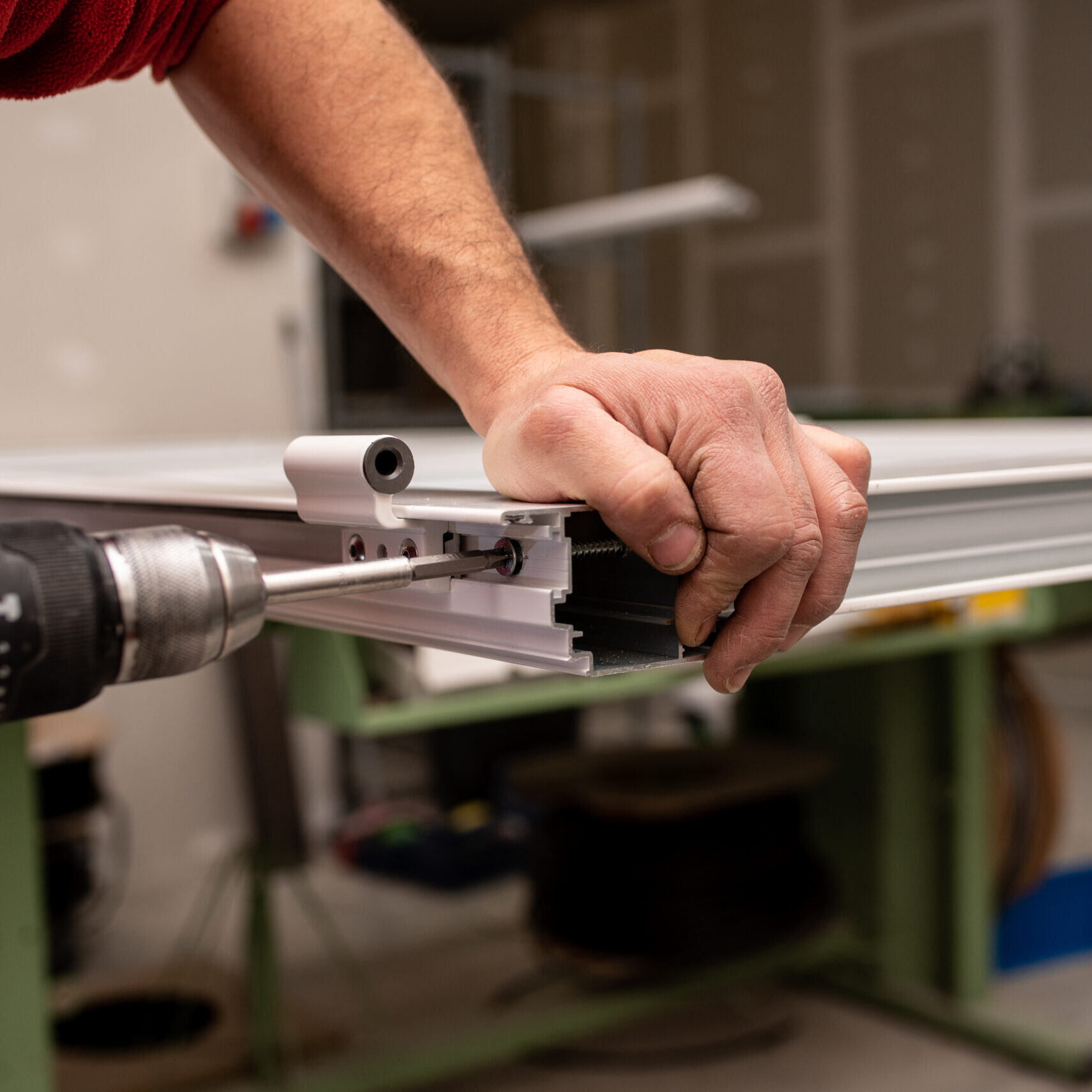 Male With A Red Shirt Making A Window With Industrial Tools Male With A Red Shirt Making A Window With Industrial Tools