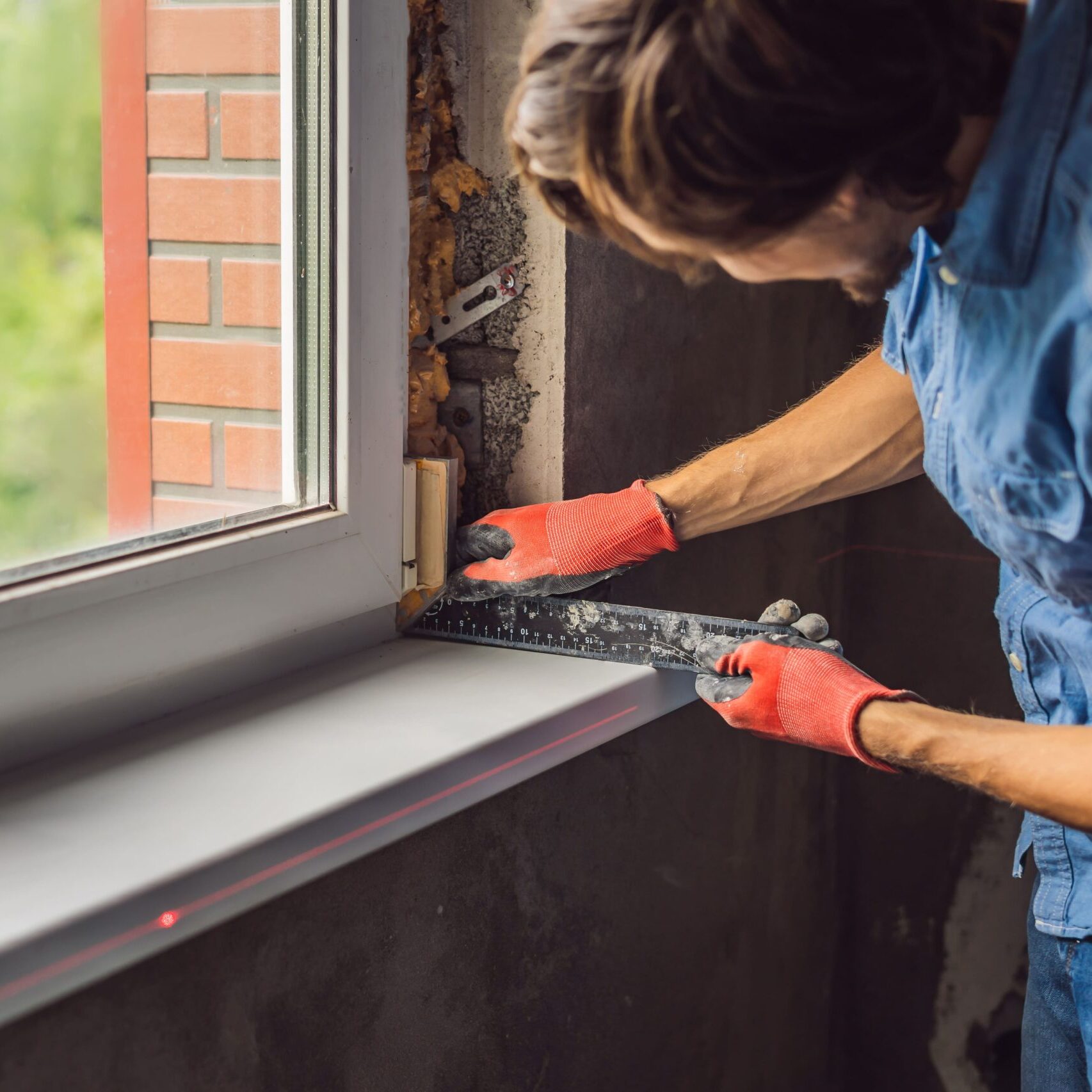 Man Blue Shirt Does Window Installation Man Blue Shirt Does Window Installation