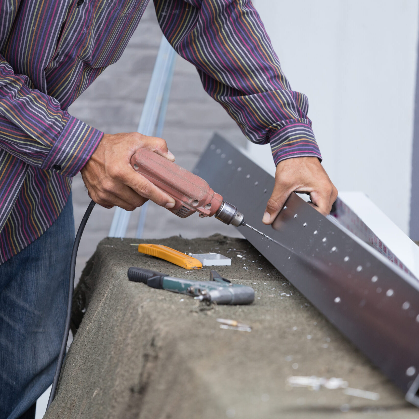 Worker Drilling Holes In Aluminium Construction Frame With Elect Worker Drilling Holes In Aluminium Construction Frame With Elect
