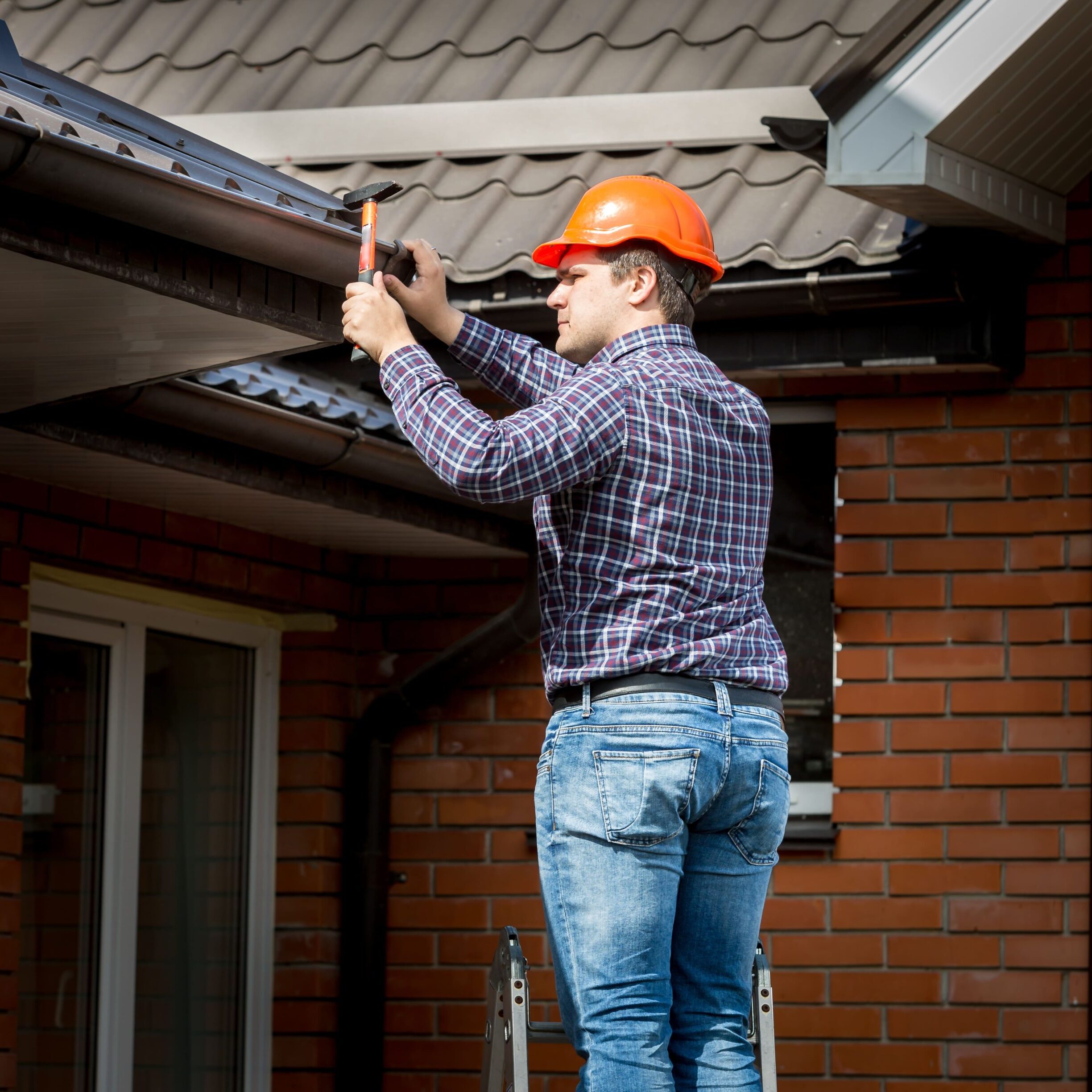 Professional Carpenter Hammering Roof Boards With Hammer Professional Carpenter Hammering Roof Boards With Hammer